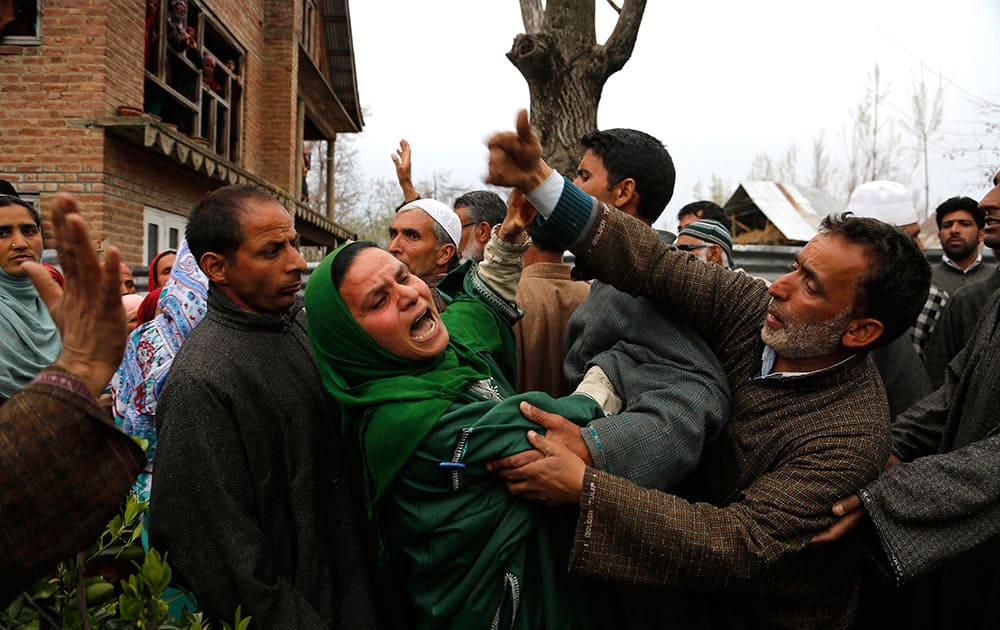 An unidentified relative of Mushraq Ahmad, an Indian policeman shot dead by suspected rebels, wails during his funeral procession in Arigam, some 32 Kilometers (20 miles) south of Srinagar, India.