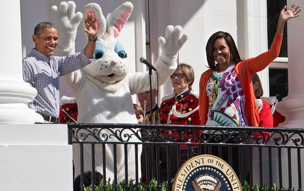 President Barack Obama and first lady Michelle Obama wave with the Easter Bunny as they greet families participating in the White House Easter Egg Roll on the South Lawn of White House in Washington.