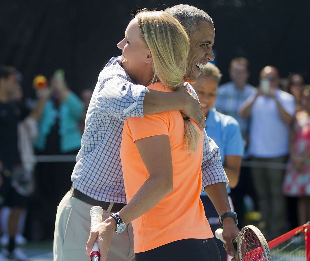 President Barack Obama hugs Caroline Wozniacki, a Danish professional tennis player, after playing against each other at the White House Easter Egg Roll on the South Lawn of White House in Washington.