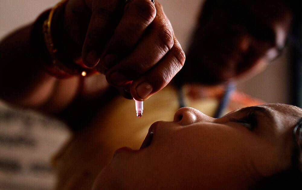 A health worker administers a polio drop to an infant as part of Mission Indradhanush on World Health Day in Bhubaneswar.