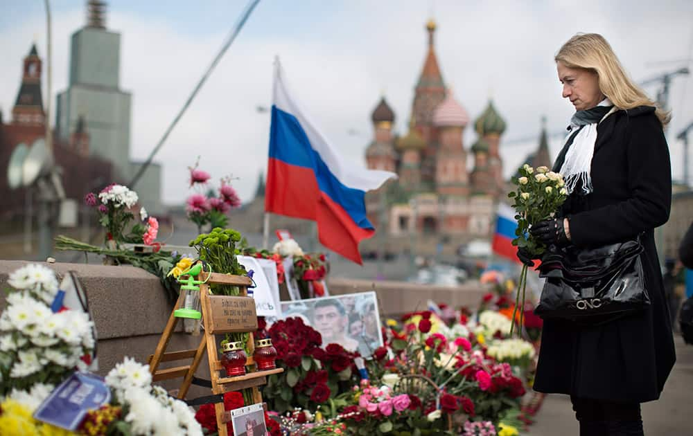 A woman lays a flower tribute at a place where Boris Nemtsov, a charismatic Russian opposition leader and sharp critic of President Vladimir Putin, was gunned down on Feb. 27, 2015 near the Kremlin in Moscow, Russia.