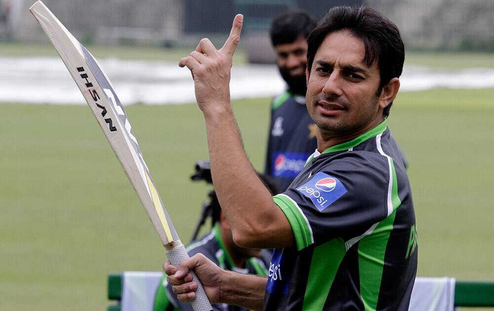 Newly inducted cricketer Saeed Ajmal holds up a finger during a practice session in Lahore, Pakistan. Pakistan's cricket team is due to arrive in Bangladesh next Monday for three ODIs, a Twenty20 match and two test matches. 