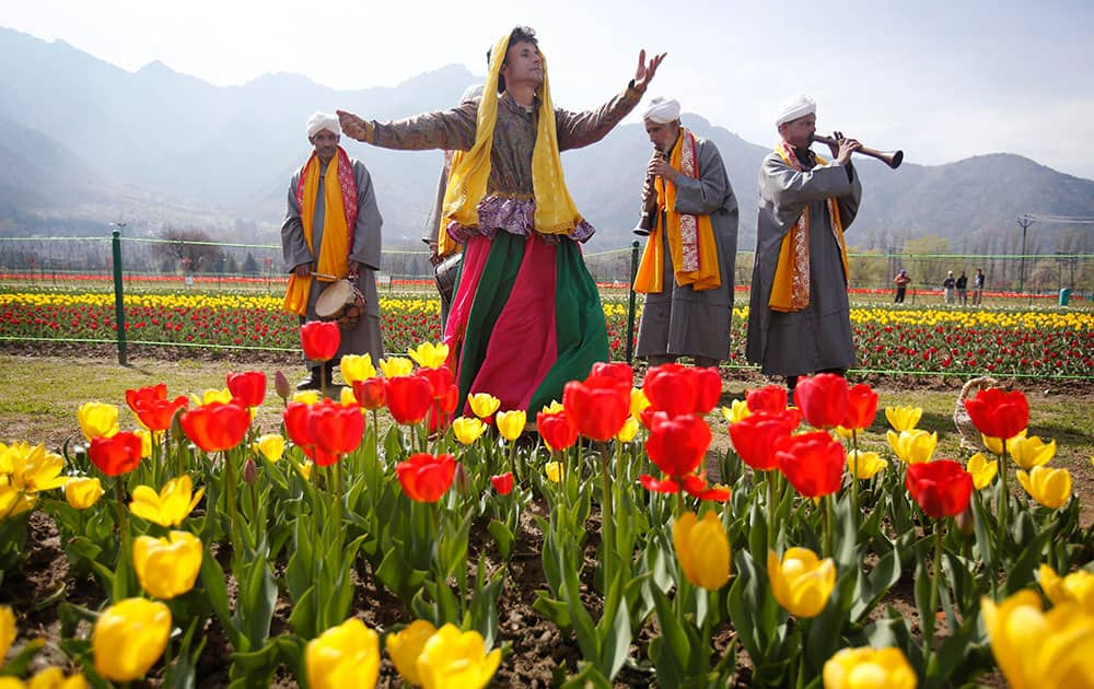 Kashmiri traditional folk dancers perform during the season's opening of Siraj Bagh, claimed to be the largest tulip garden in Asia, on Zabarwan Hills in Srinagar.