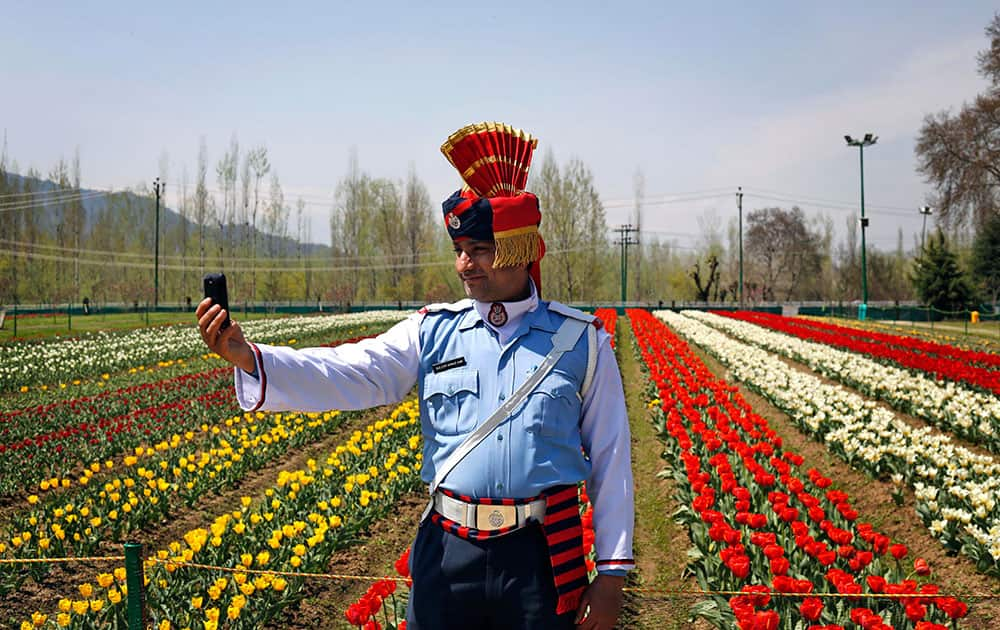 A Jammu and Kashmiri state traffic policeman takes a 