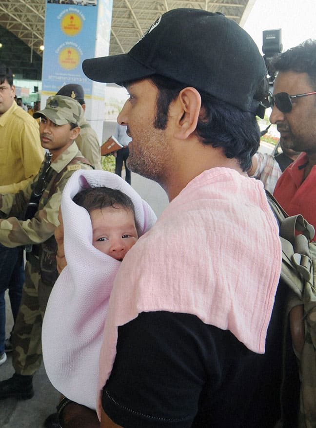 Indian cricket team captain Mahendra Singh Dhoni with his infant daughter at Birsa Munda International Airport, Hinoo in Ranch.