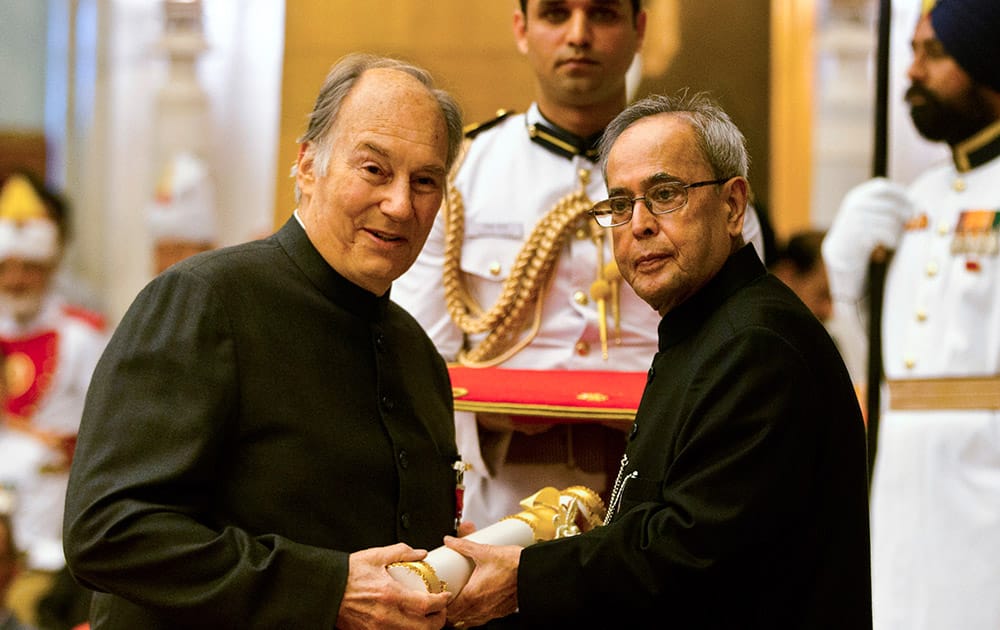 President Pranab Mukherjee confers the Padma Vibhushan to the Aga Khan, spiritual head of Ismaili Muslims, left, during a civil investiture ceremony at the presidential palace in New Delhi.