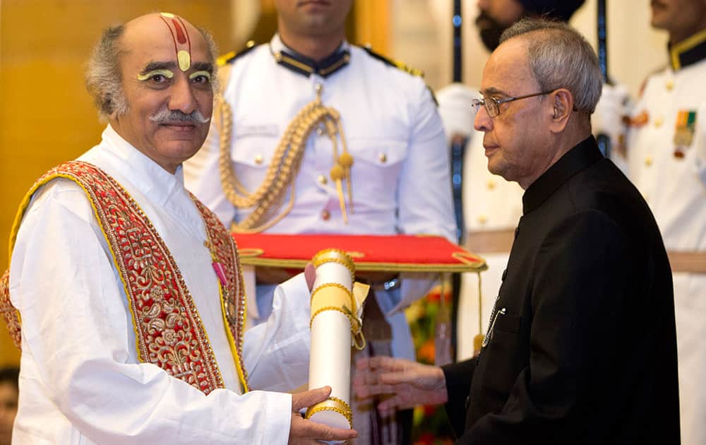 President Pranab Mukherjee, confers the Padma Bhushan to Indian classical vocalist Pandit Gokulotsavji Maharaj during a civil investiture ceremony at the presidential palace, in New Delhi.