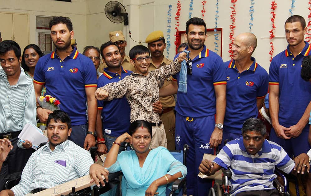 Delhi Daredevils players interacting with special children at a society.