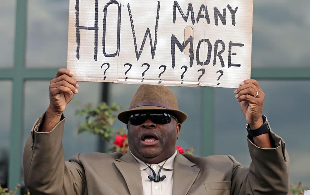 Rev. Arthur Prioleau holds a sign during a protest in the shooting death of Walter Scott at city hall in North Charleston, S.C.