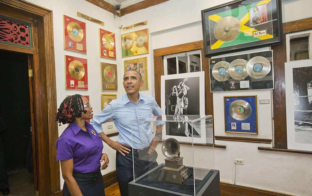 President Barack Obama visits the Bob Marley Museum with tour guide Natasha Clark, in Kingston, Jamaica.
