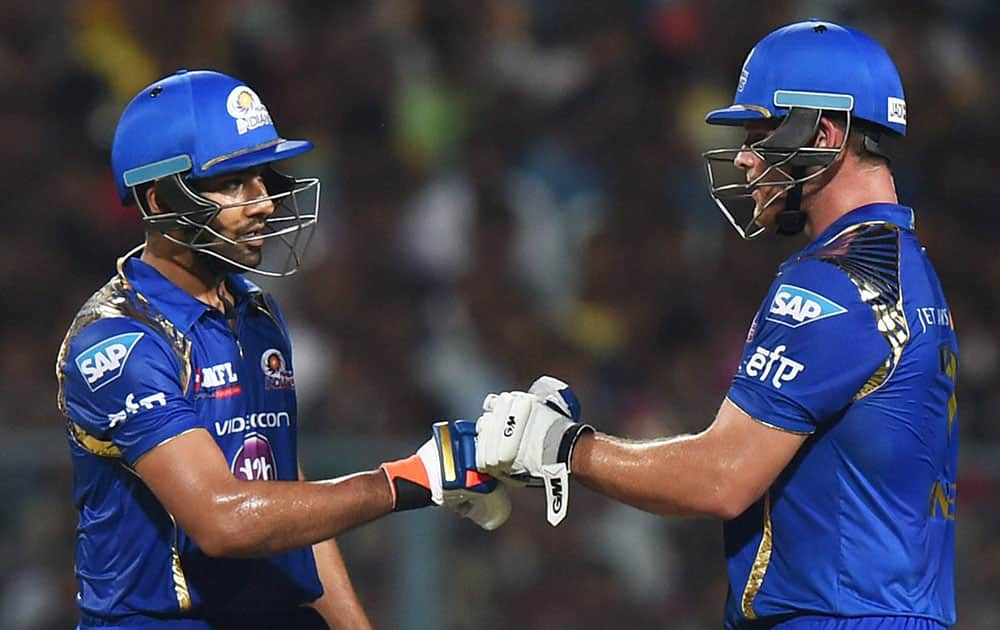 Mumbai Indians batsman Rohit Sharma being greeted by his teammate C. Anderson after completes his half century during 1st IPL-2015 Match against KKR at Eden Garden in Kolkata.