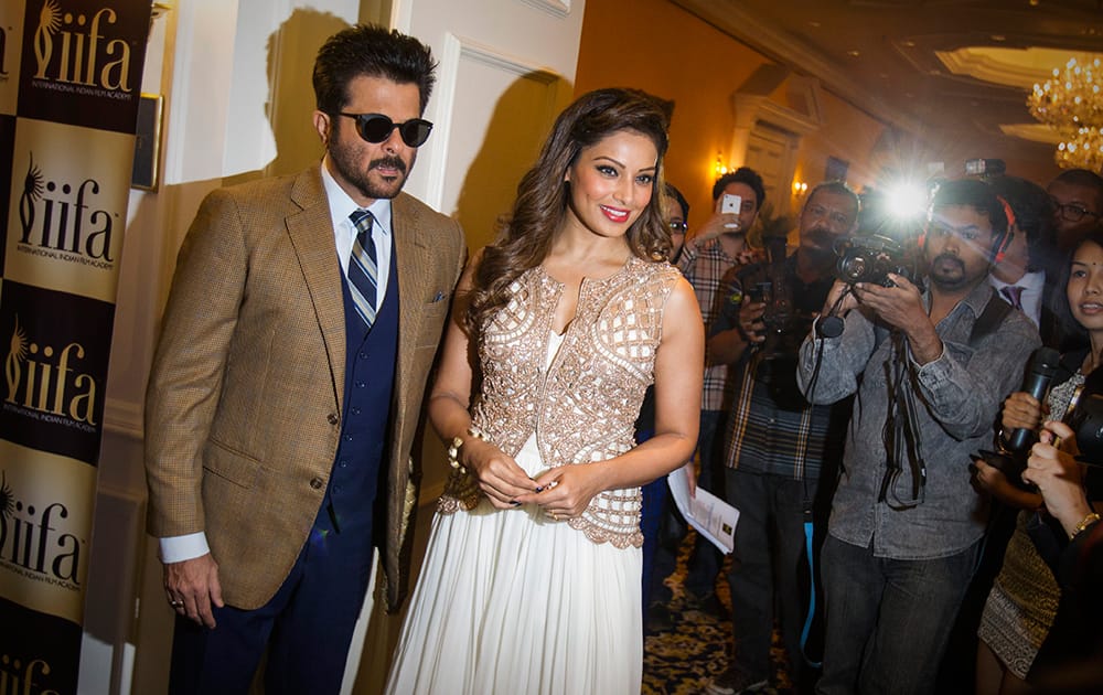 Actors Anil Kapoor and Bipasha Basu pose for the media as they arrive at the International Indian Film Awards (IIFA) press conference at a hotel in Kuala Lumpur, Malaysia.