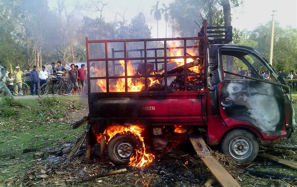 A vehicle is set on fire by an angry mob after a woman was killed in a road accident after she was hit by a vehicle, in Nagaon.