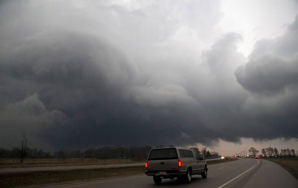 A storm moves over US 20 on Thursday, April 9, in Belvidere, lll. At least one large tornado touched down Thursday night in central Illinois, causing significant damage.