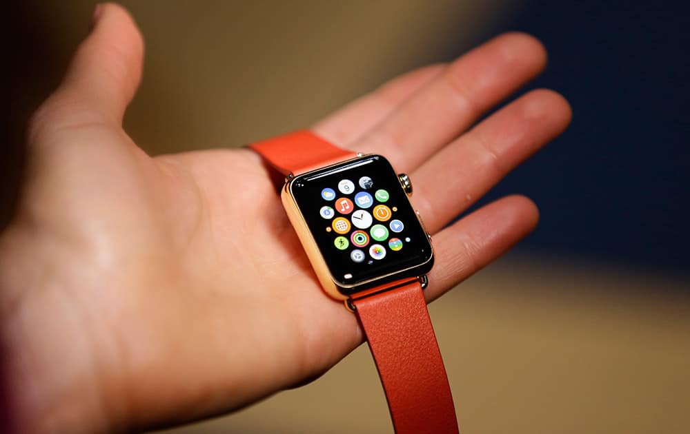 A woman holds the Apple Watch during a demo following an Apple event in San Francisco. Pre-orders for the Apple Watch begin Friday, April 10, 2015.