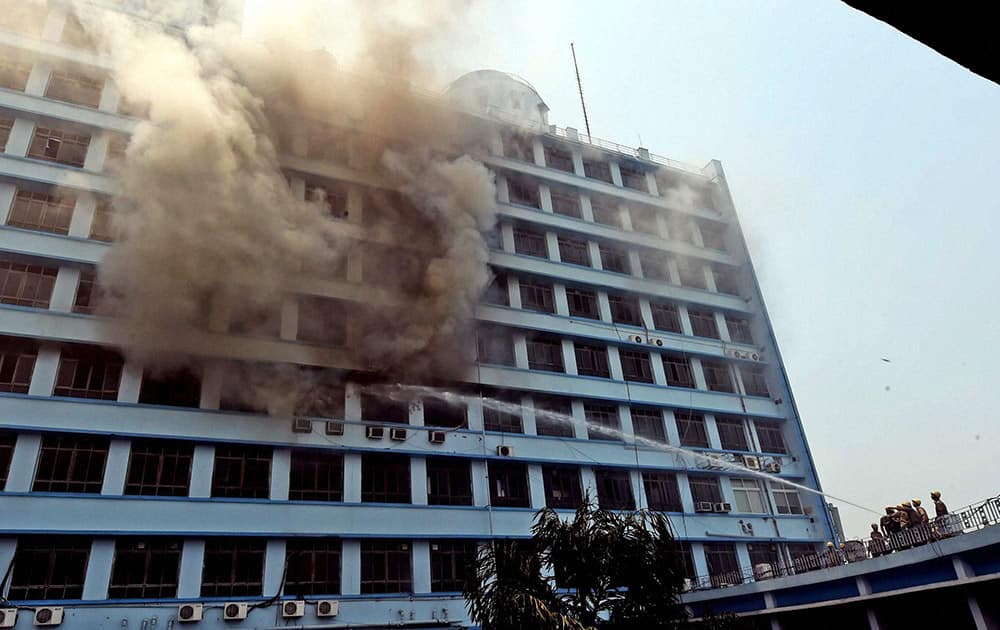 Fire Brigade personnel try to douse the fire after 7th floor of New Secretariat building caught fire in Kolkata.