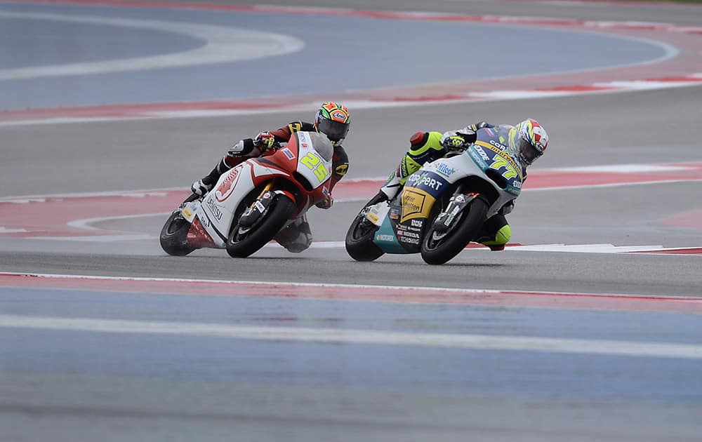 Azlan Shah (25), of Malaysia, and Dominique Aegerter (77), of Switzerland, steer through a turn during a Moto2 open practice session for the MotoGP Grand Prix of the Americas motorcycle race at the Circuit of the Americas.