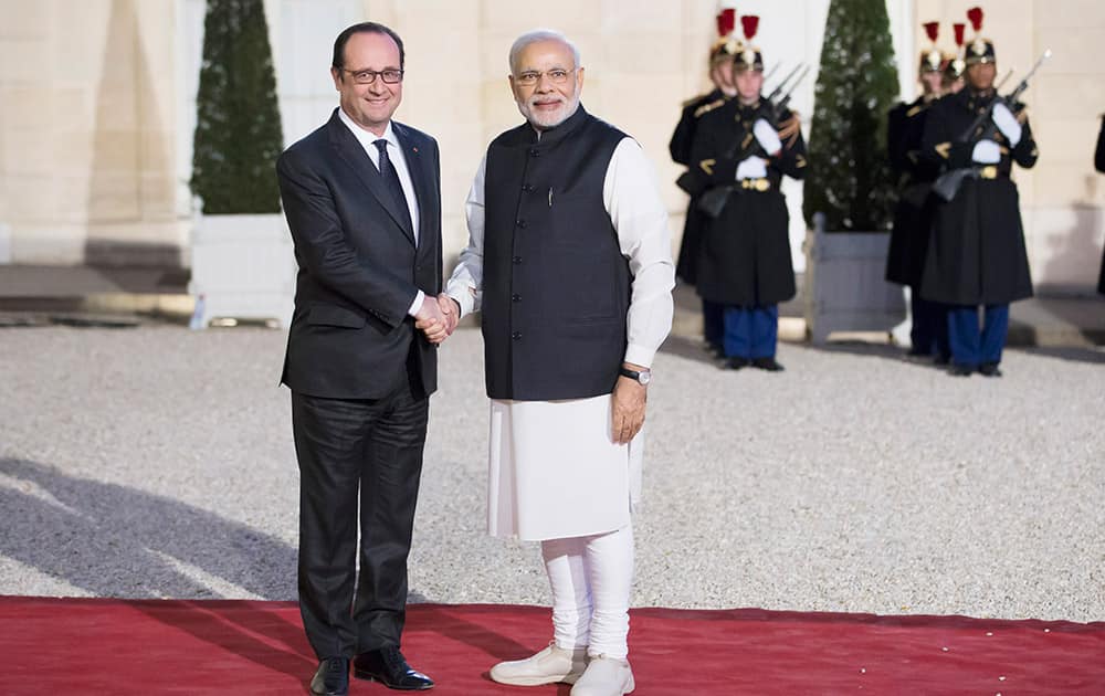 French president Francois Hollande, greets Indian prime minister Narendra Modi as he arrives for an official dinner at the Elysee Palace in Paris.