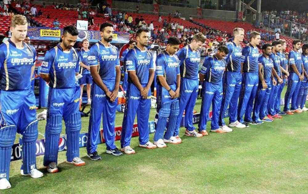 Rajasthan Royals players stand for a minute silence as they pay tribute to commentator Richie Benaud before the start of their IPL match against Kings XI Punjab in Pune.