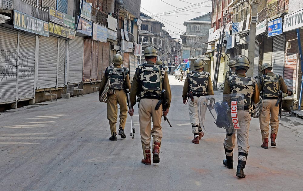 Security personnel patrolling a street during a strike call given by separatist groups against reported government plan for setting up a separate township for Kashmiri Pandits, at Lal Chowk in Srinagar.