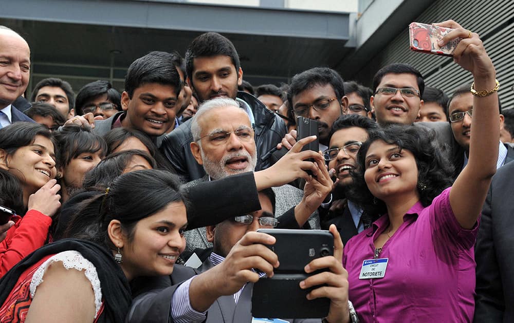 Prime Minister Narendra Modi takes a selfie with Indian employees during a visit to the Airbus facility in Toulouse, France.