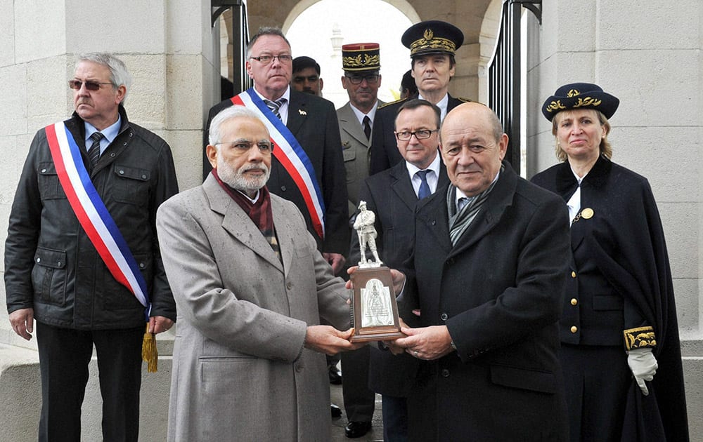 Prime Minister Narendra Modi is presented a memento during a visit to the Indian Memorial at the Neuve Chapelle in France. The memorial commemorates Indians who sacrificed their lives in World War I. 