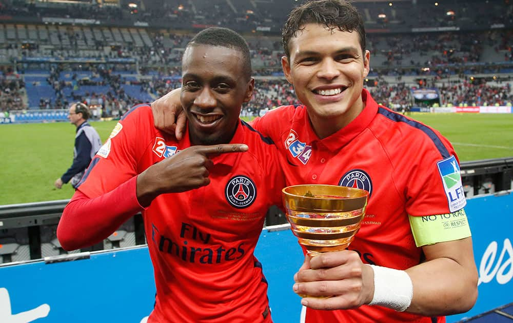 Paris Saint Germain's Blaise Matuidi, left, and captain Thiago Silva, right, pose after their League Cup final soccer match against Bastia at Stade de France stadium in Saint Denis, outside Paris, France.