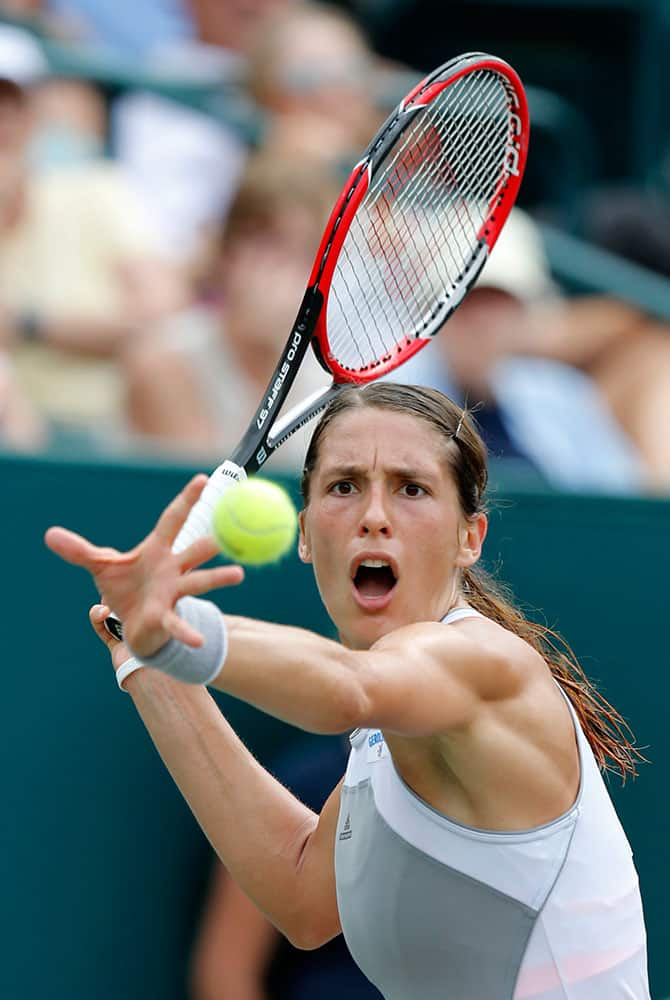 Andrea Petkovic, from Germany, returns to Angelique Kerber during semifinal action at the Family Circle Cup tennis tournament in Charleston, S.C.