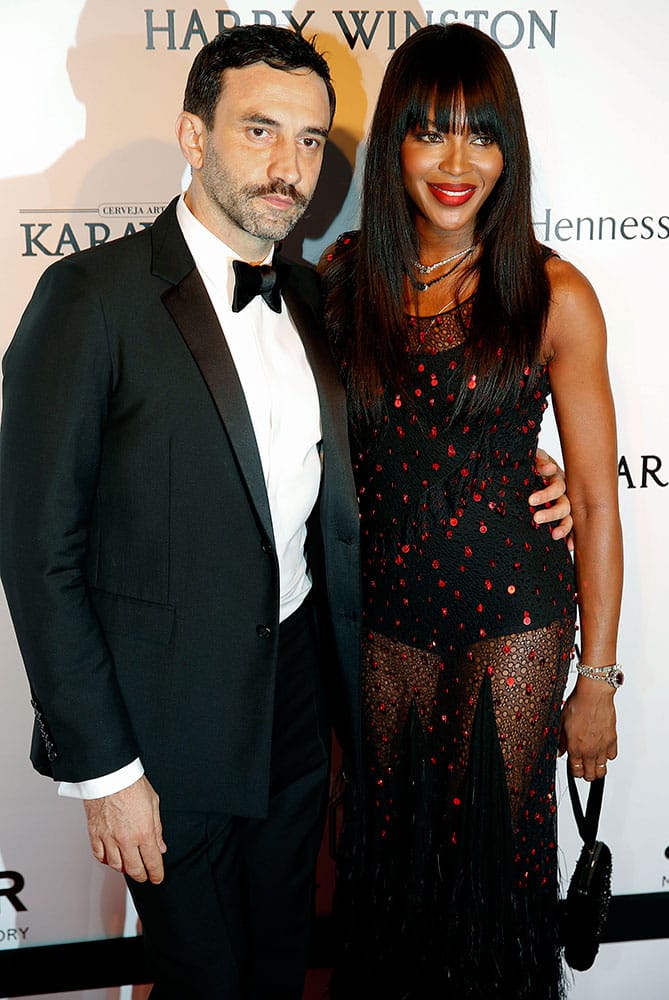 British model Naomi Campbell, right, and Italy's fashion designer Riccardo Tisci pose on the red carpet at The Foundation for AIDS Research (amfAR) event in Sao Paulo, Brazil.