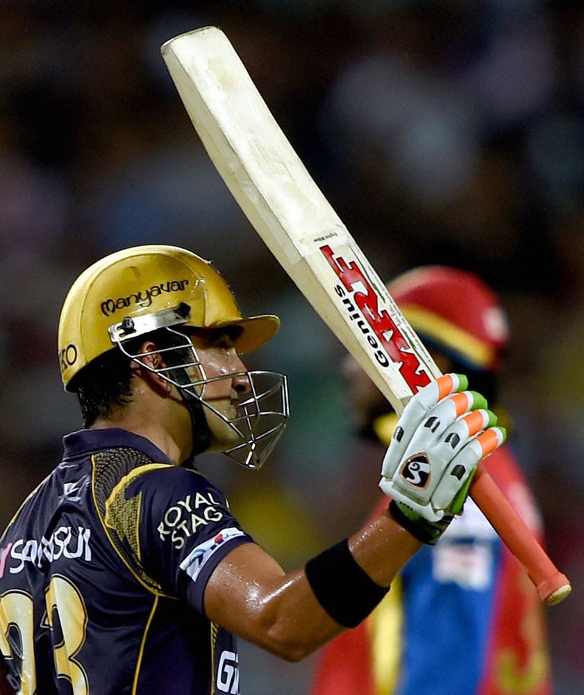 KKRs captain Gautam Gambhir raise his bat after completes his half century against Royal Challengers Bangalore during an IPL-2015 match at Eden Garden in Kolkata.