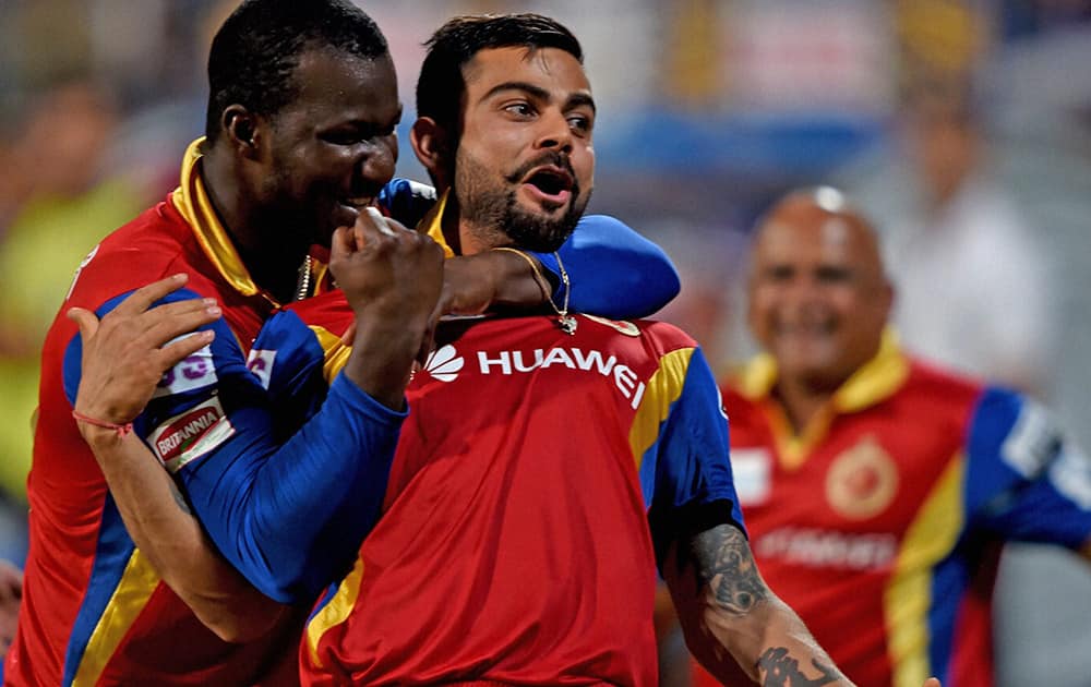 RCB players Virat Kohli with D Sammy celebrates after win over Kolkata Knight Riders during theirIPL-2015 match at Eden Garden in Kolkata.