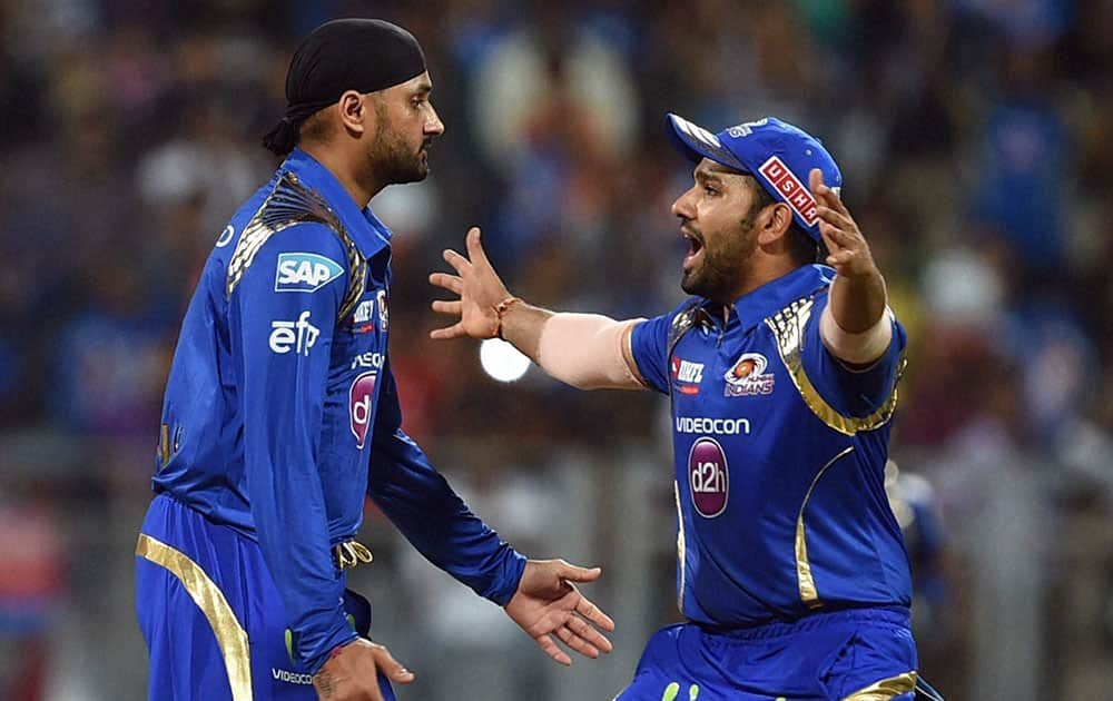 Mumbai Indians bowler Harbhajan Singh celebrates the wicket of Kings XI Punjab batsman Sehwag plays during the IPL T20 match played in Mumbai.