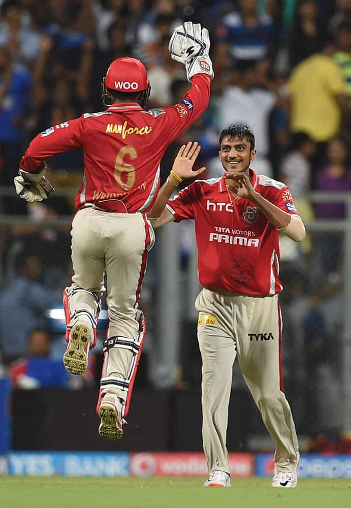 Kings XI Punjab bowler Axar Patel celebrates a wicket of Mumbai Indians batsman Pollard during a IPL T20 match played in Mumbai.