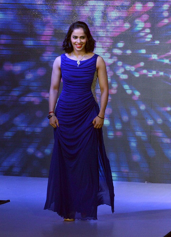 Badminton player Saina Nehwal walks on the ramp at a promotional event in Hyderabad.