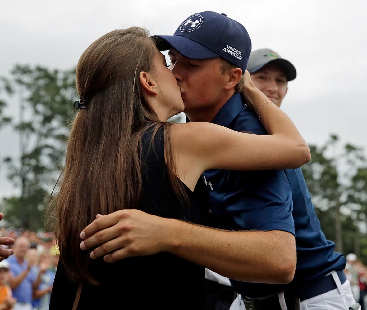 Jordan Spieth kisses his girlfriend, Annie Verret, after winning the Masters golf tournament, in Augusta, Ga. 