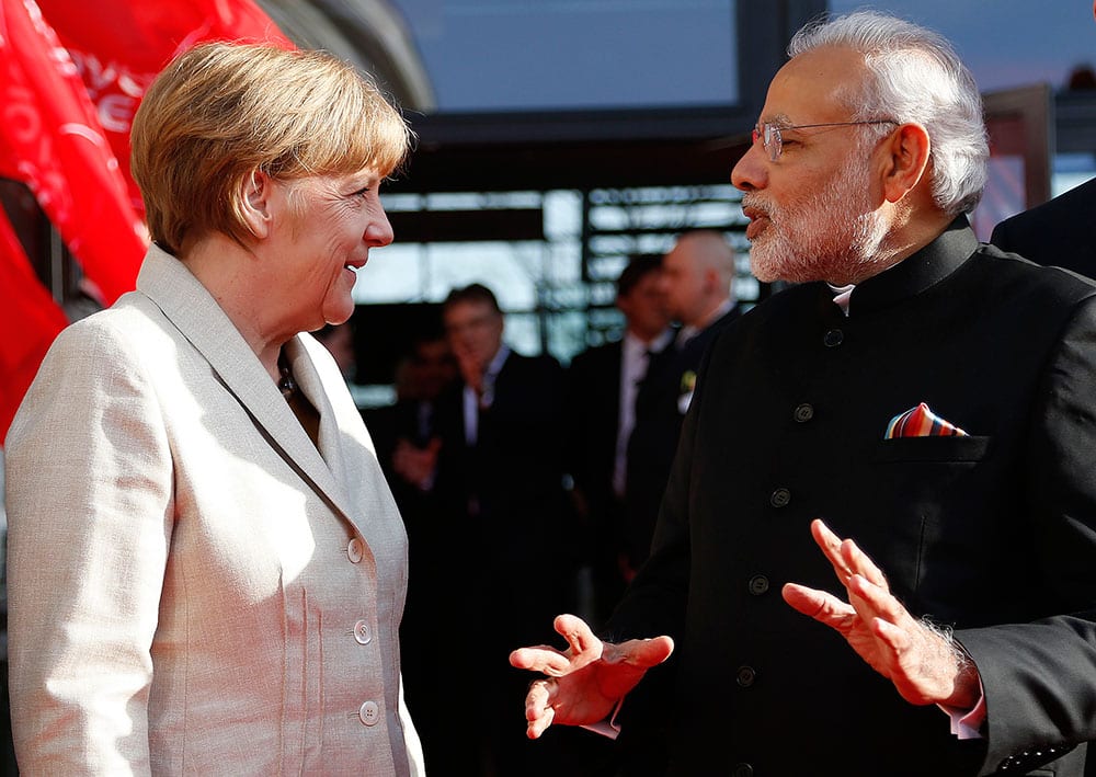 German Chancellor Angela Merkel welcomes India's Prime Minister Narendra Modi at the opening of the industrial fair in Hanover, Germany.