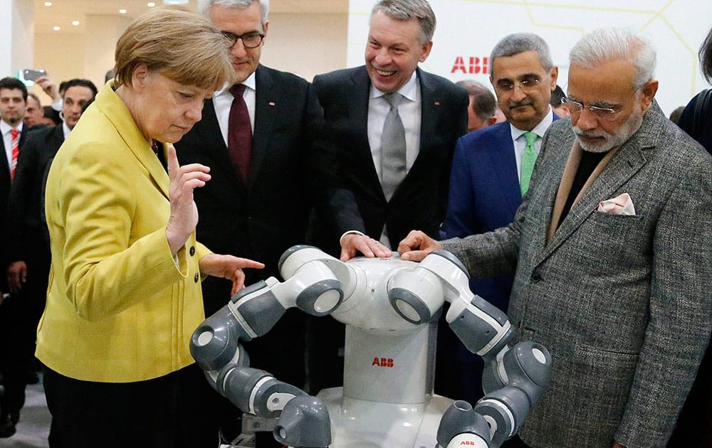 German Chancellor Angela Merkel and India's Prime Minister Narendra Modi get explanations from German ABB boss Ulrich Spiesshofer next to ABB CEO Hans-Georg Krabbe, during the opening of the industrial fair in Hanover, Germany.