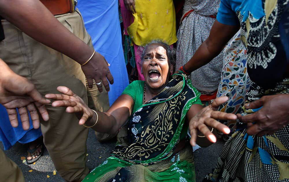 A relative of one of the children who died in the collapse of a school wall reacts as people gather at the spot after the accident in Chennai.