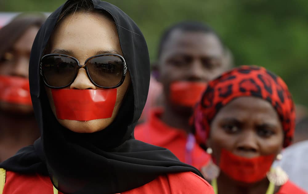 People march during a silent protest calling on the government to rescue the kidnapped girls of the government secondary school in Chibok, who were abducted a year ago, in Abuja, Nigeria.
