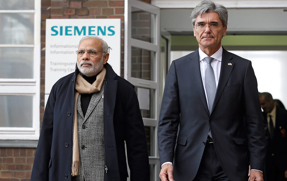 Siemens CEO Joe Kaeser and the Prime Minister of India, Narendra Modi, leave a company building after a visit of the Siemens company in Berlin, Germany.