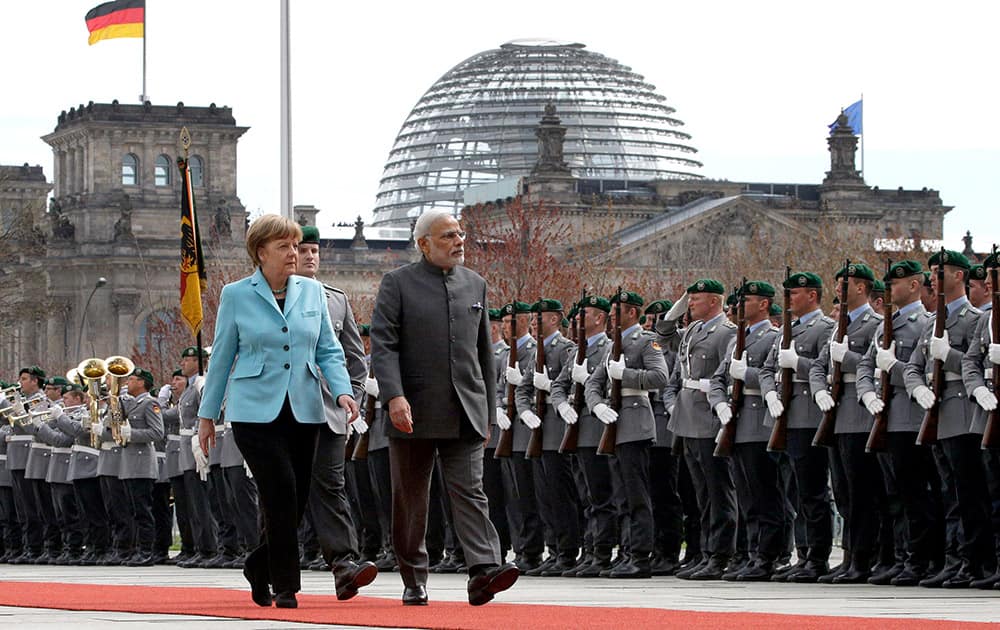 German Chancellor Angela Merkel welcomes the Prime Minister of India Narendra Modi with military honors for a meeting at the chancellery in Berlin, Germany.