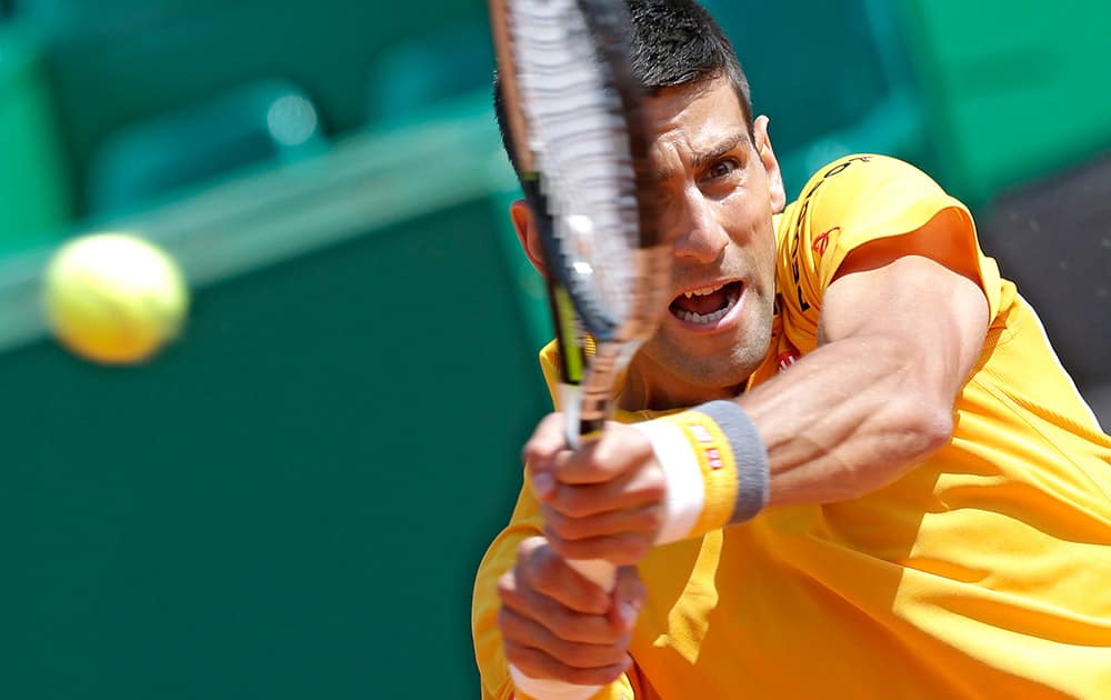 Novak Djokovic of Serbia plays a return to Albert Ramos Vinolas of Spain during their match of the Monte Carlo Tennis Masters tournament in Monaco.
