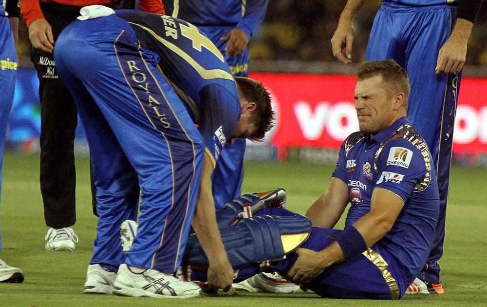 Mumbai Indians player Aaron Finch reacts after being hit by a ball during their IPL 2015 between Rajasthan Royals and Mumbai Indians at the Sardar Patel Stadium.