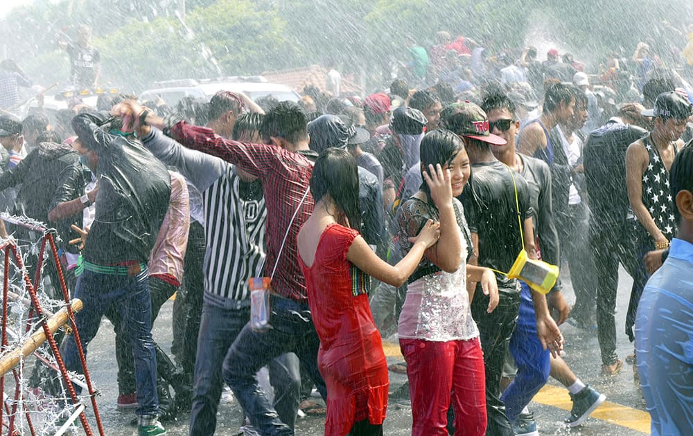 Merrymakers are soaking wet as they are sprayed water from a pandal during the annual Thingyan water festival celebrations, in Yangon, Myanmar.