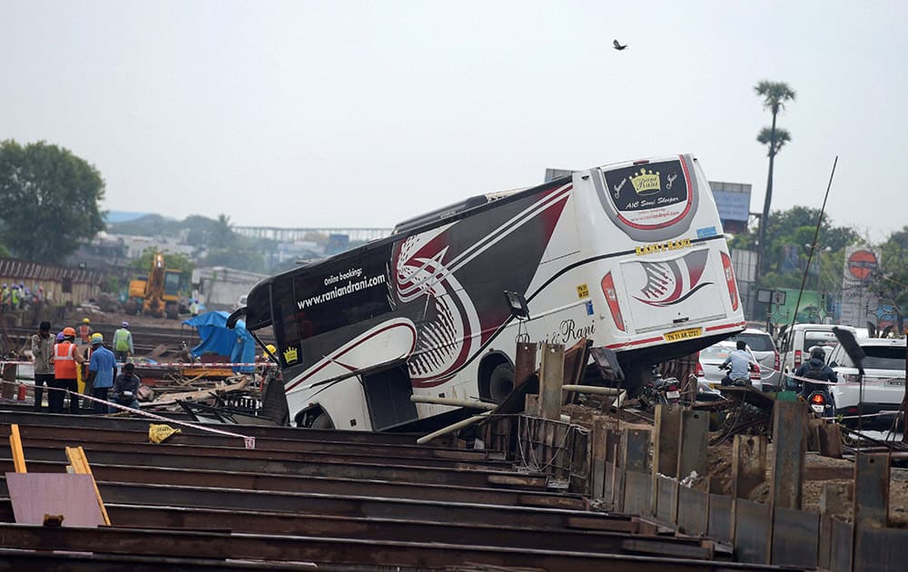 A bus hangs on the Chennai Metro Train Project work site, near Chennai Airport.