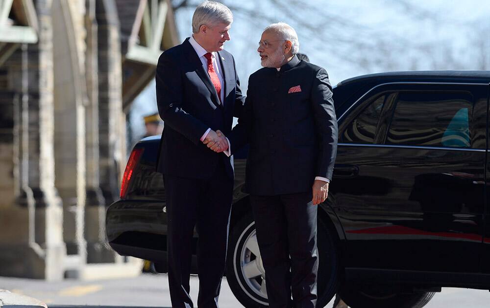 Canadian Prime Minister Stephen Harper greets Indian Prime Minister Narendra Modi on Parliament Hill in Ottawa.