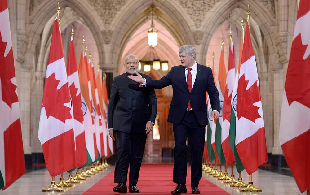 Prime Minister Narendra Modi and Canadian Prime Minister Stephen Harper walk down the Hall of Honor on Parliament Hill in Ottawa.