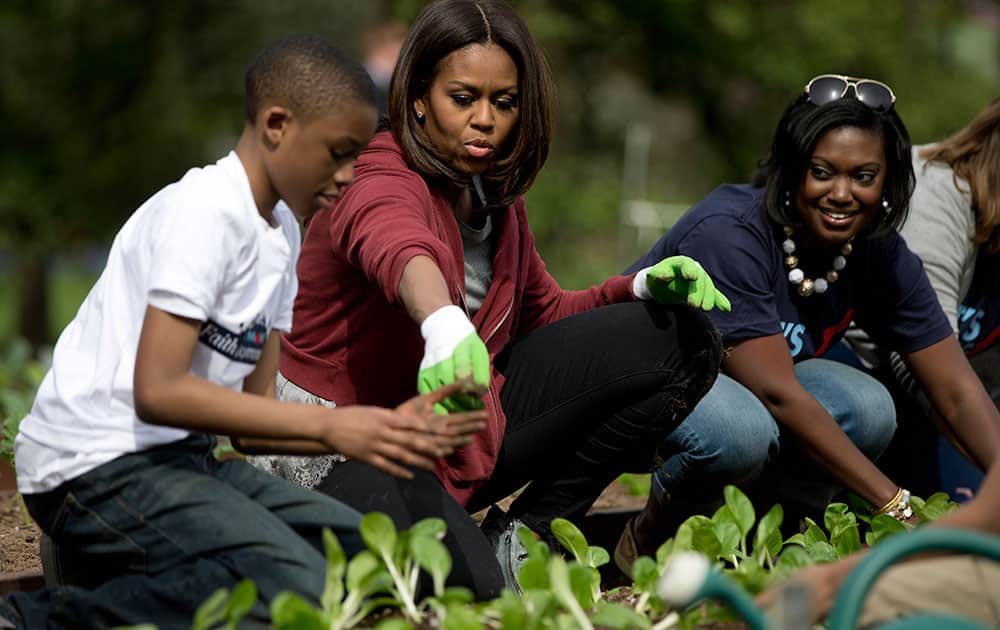 First lady Michelle Obama, joined by students from across the country, plants vegetables during the seventh annual White House Kitchen Garden Planting on the South Lawn of the White House in Washington.