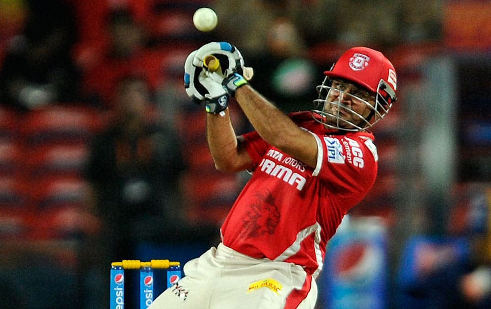 Kings XI Punjab player Virender Sehwag plays a shot during an IPL match with Delhi Daredevils in Pune.