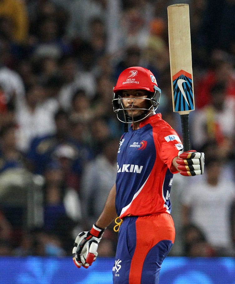 Daredevils player Mayank Agarwal raises his bat after scoring a fifty against Kings XI Punjab during an IPL T20 match in Pune.